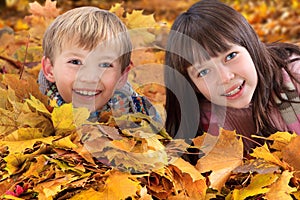 Siblings in fallen leaves
