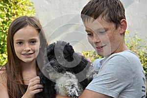 Siblings and her harlequin poodle