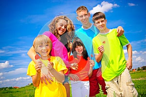 Siblings hold flowers.