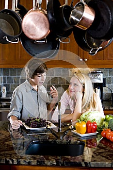 Siblings in kitchen chatting