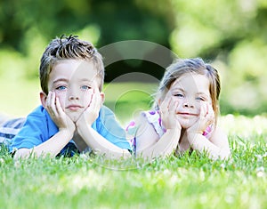 Siblings laying in the grass