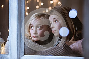 Siblings looking out the window