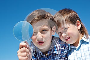 Siblings with magnifying glass