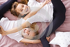 Siblings playing in bed