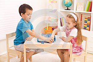 Siblings playing chess in the kid's room