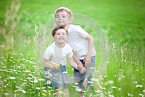 Siblings playing in field