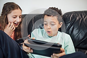 Siblings Playing with Game Consoles