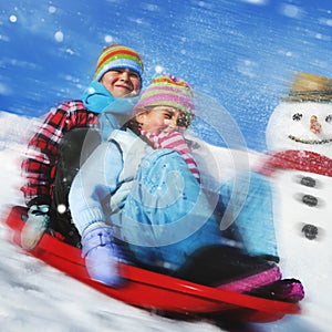 Siblings Playing Snow Sledge In The Snow Concept