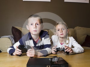 Siblings playing video games photo