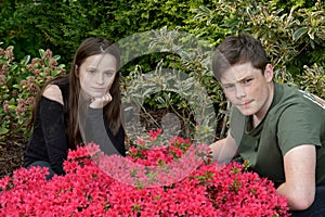 Siblings posing for photos in the garden