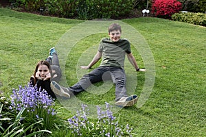 Siblings relaxing in garden