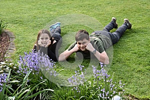 Siblings relaxing in garden