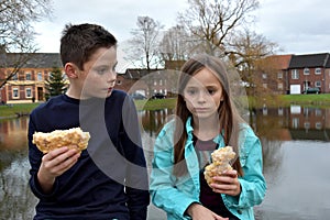 Siblings sharing pastry