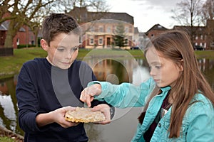 Siblings sharing pastry