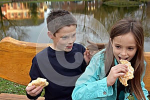 Siblings sharing a piece of pastry