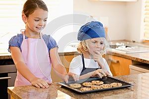 Siblings stealing cookies