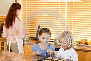 Siblings stealing cookies together