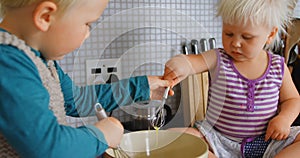 Siblings stirring eggs with whisker 4k