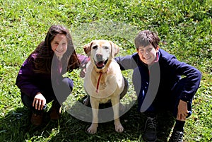 siblings with their big labrador dog