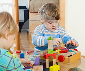 Siblings together playing with blocks
