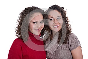 Siblings: two monozygotic young twin womans in portrait isolated