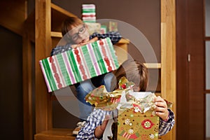 Siblings unwrapping Christmas presents