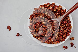 Sichuan pepper. Chinese pepper Zanthoxylum schinifolium in bowl, top view