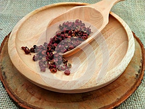 Sichuan pepper or Szechuan peppercorn or Chinese prickly ash or Mala pepper on Wooden Surface