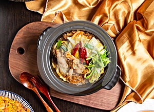 Sichuan Style Winter Noodles Claypot with fork and spoon served in dish isolated on wooden board top view of asian food