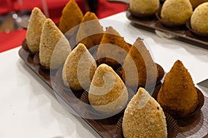 Sicilian Rice â€œAranciniâ€œ displayed Row in Various Flavors, Italian Food