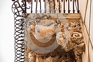 Sicily, Noto town the Baroque Wonder - UNESCO Heritage Site. Detail of Palazzo Nicolaci balcony, the maximum expression of the