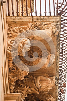 Sicily, Noto town the Baroque Wonder - UNESCO Heritage Site. Detail of Palazzo Nicolaci balcony, the maximum expression of the