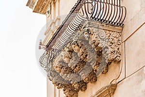 Sicily, Noto town the Baroque Wonder - UNESCO Heritage Site. Detail of Palazzo Nicolaci balcony, the maximum expression of the