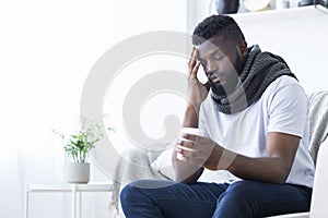 Sick african american man drinking hot healing tea