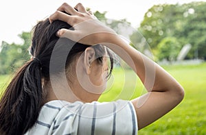 Sick asian child girl holding her painful head, brain cancer,hemorrhagic stroke and tumor inside brain,female teenage person with photo