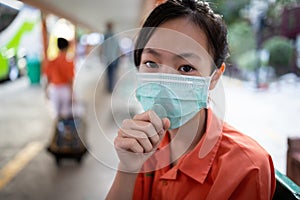 Sick asian child girl student wearing Thai school uniform with hygienic mask,health care,dust,air pollution,Pm2.5,virus protection photo