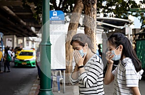 Sick asian family,mother,daughter cough,sneezing,woman,child girl wearing protective mask have severe allergic reaction to dust,