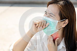 Sick asian female people with tonsillitis angina,woman wearing mask,touch the neck with cough,sore throat pain irritation,hard to photo