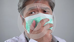 Sick Asian man wearing a medical face mask and Coughing and covering his mouth with my hand. Concept of protection pandemic