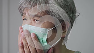 Sick Asian man wearing a medical face mask and Coughing and covering his mouth with my hand. Concept of protection pandemic