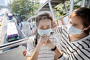 Sick asian people wearing protective mask,child girl has cough,choking on air pollution,problems of toxic dust,smog,fine dust,air