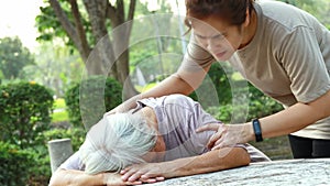 Sick asian senior woman fainted unconscious at the table, fall face down,elderly female patient stop breathing due to heart failur