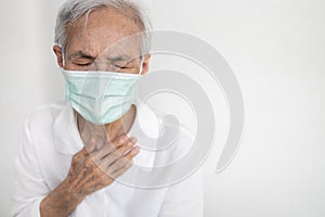 Sick asian senior woman having difficulty breathing,patient suffering from pain in chest feel tight,acute dyspnea,asthma,shortness