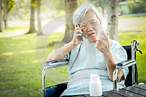 Sick asian senior woman holding bottle of medicine,.calling doctor requesting information,worried female elderly consulting,asking photo
