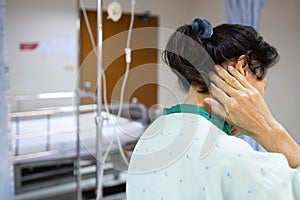 Sick asian senior woman holding occipital bone with her hand,elderly patient have severe pain in back of the head,brain tumors, photo