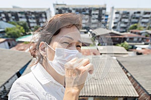 Sick asian senior woman wearing protective mask when having flu,fever,coughing to reduce the risk the spread of Coronavirus