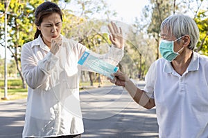 Sick asian woman with coughing,refusing to wear face mask,spread of contagious diseases,Coronavirus or Covid-19,confine,quarantine