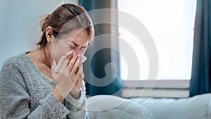 Sick asian woman have high fever flu and sneezing into tissue on bed in bedroom, Medical and health concept, Dust  PM2.5 Effect