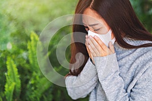 A sick asian woman wearing protective face mask for Healthcare and Covid-19 concept