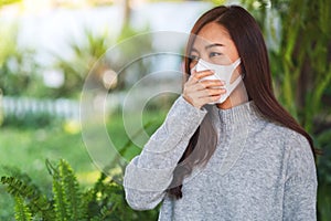 A sick asian woman wearing protective face mask for Healthcare and Covid-19 concept